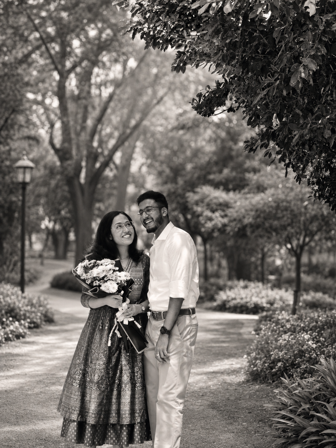 Nigel and Joanna laughing together on a tree-lined path