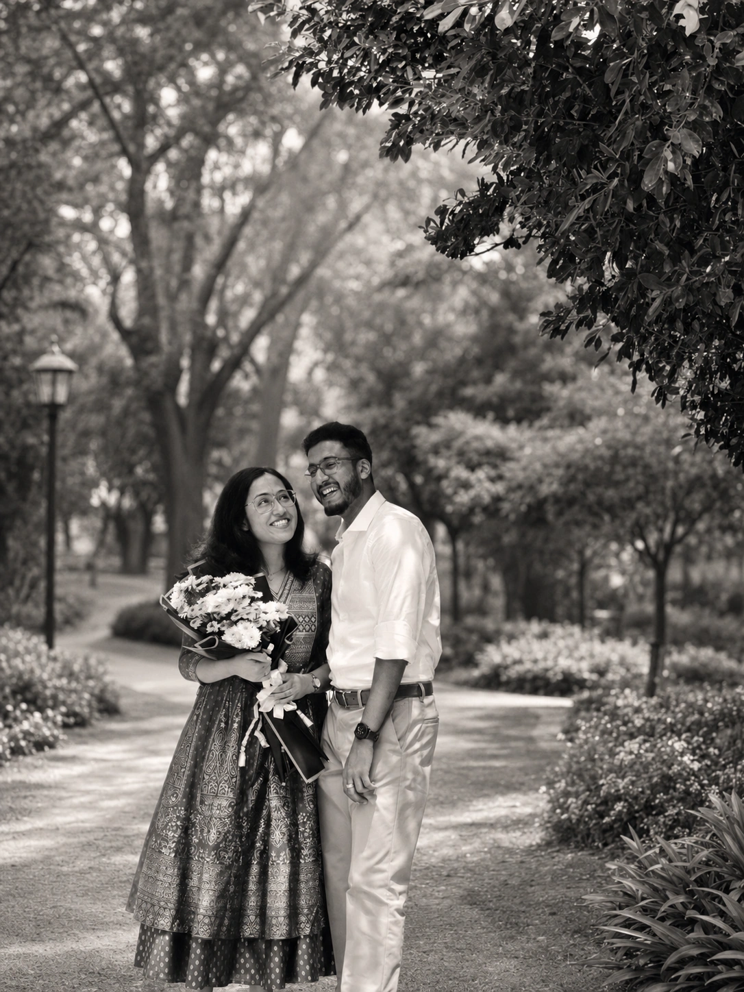 Nigel and Joanna laughing together on a tree-lined path